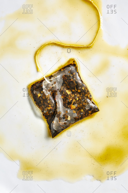 Wet herbal teabag on white background