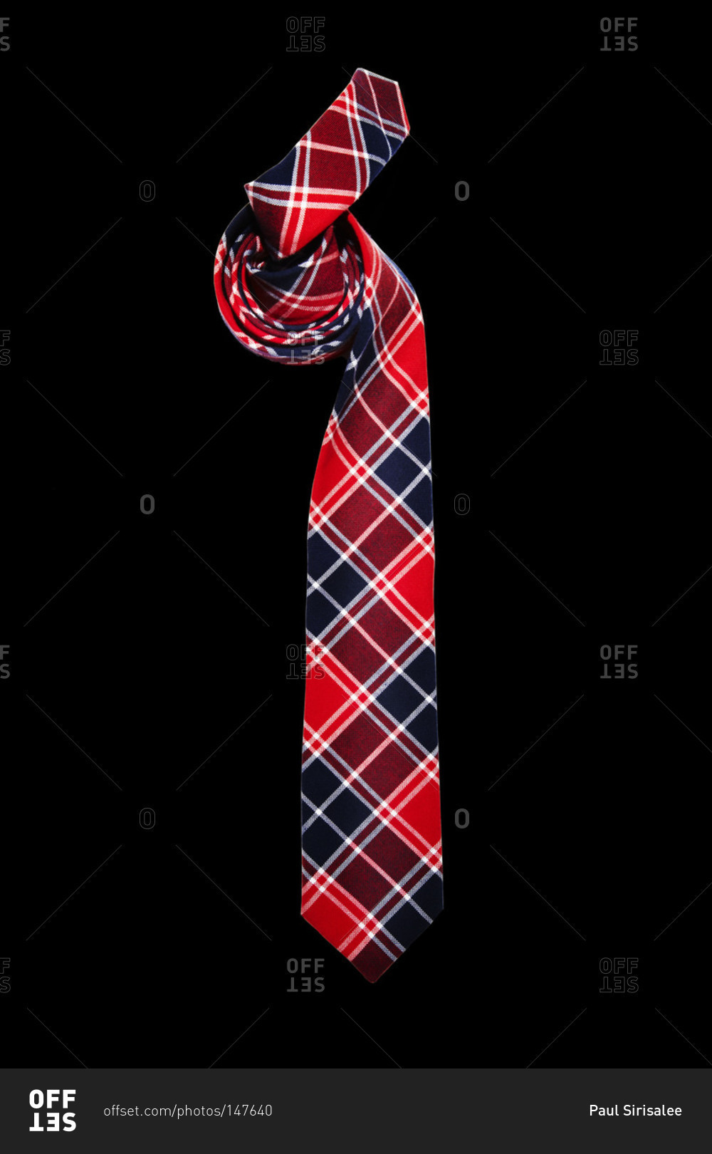 Red and blue plaid tie on black background