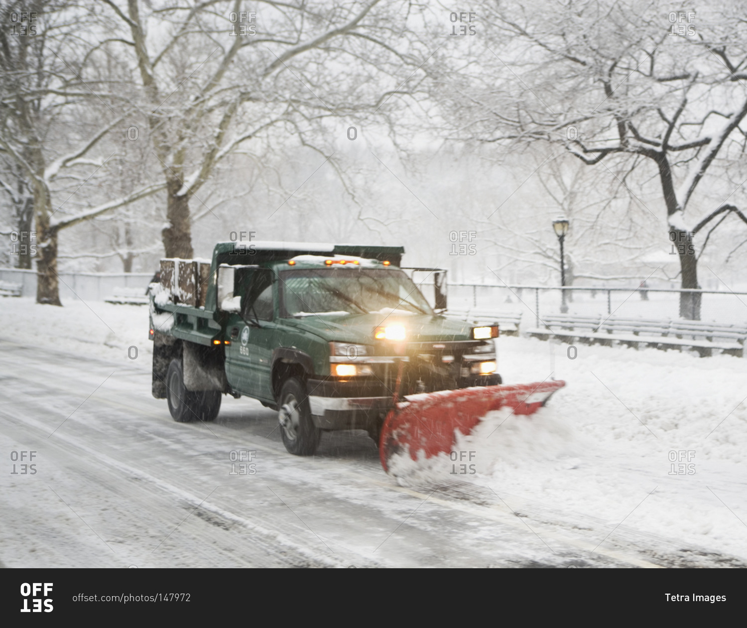 Snow plow truck clearing road