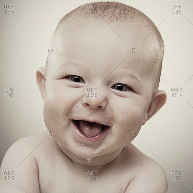 Studio portrait of baby boy (6-11 months) smiling