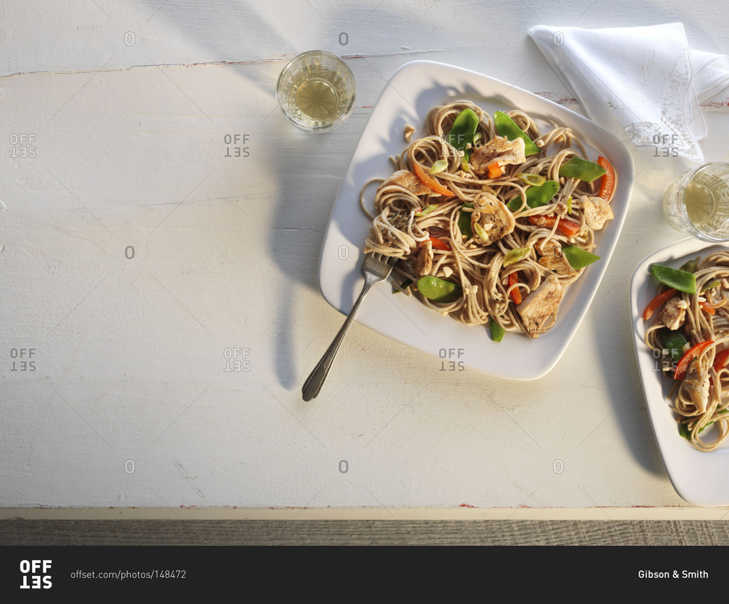 Overhead view of chicken and snow peas with whole wheat pasta