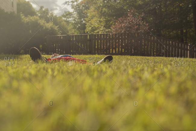 Boy lying on lawn