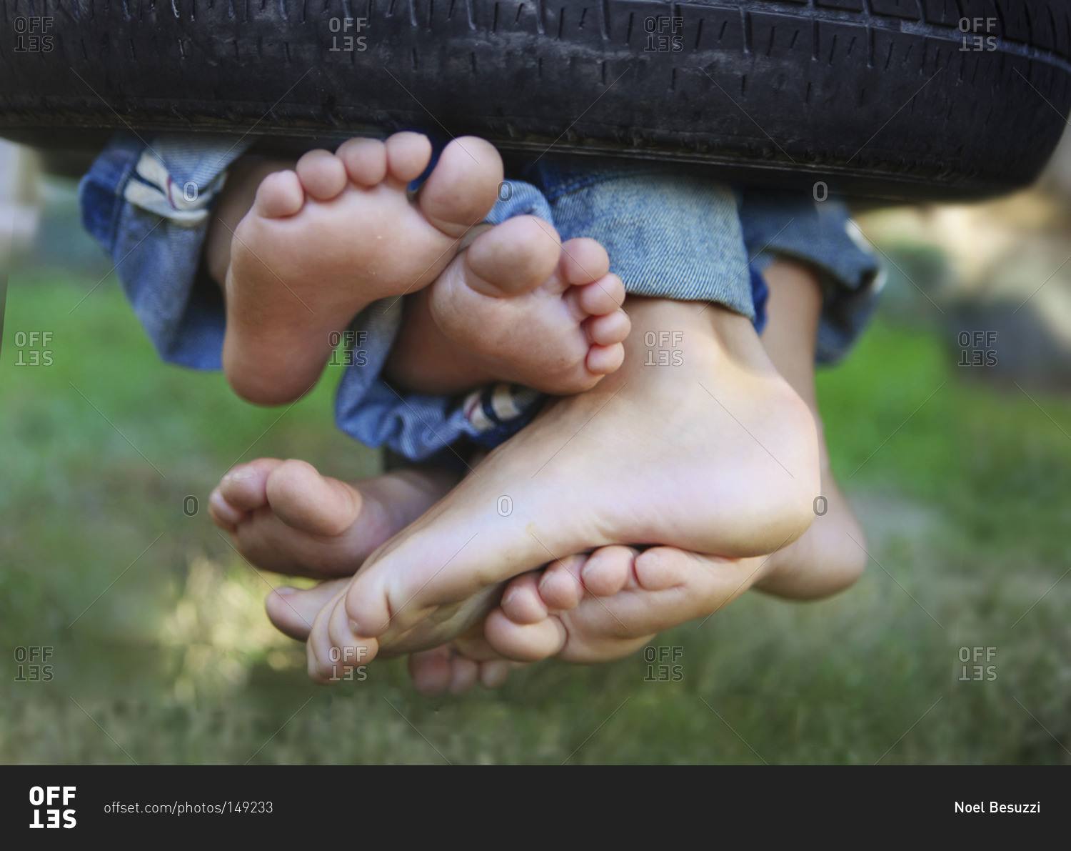 Kid's feet hanging from tire swing