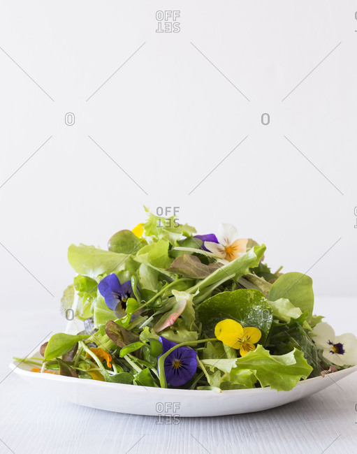 Spring salad served with edible flowers