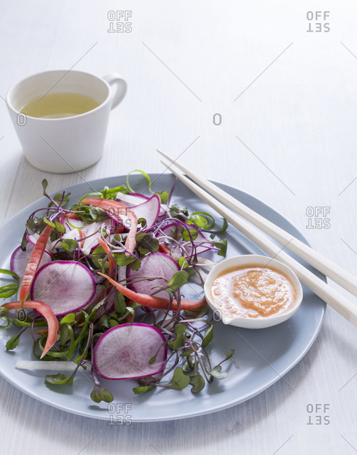 Spring salad with radishes served on a table