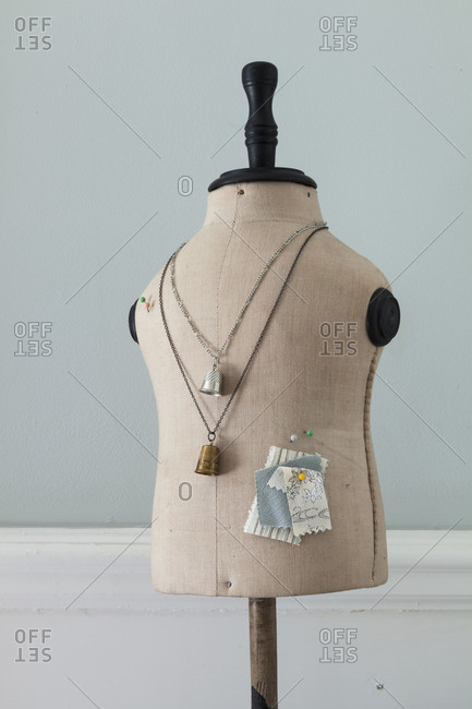 Dressmaking mannequin with thimble necklaces