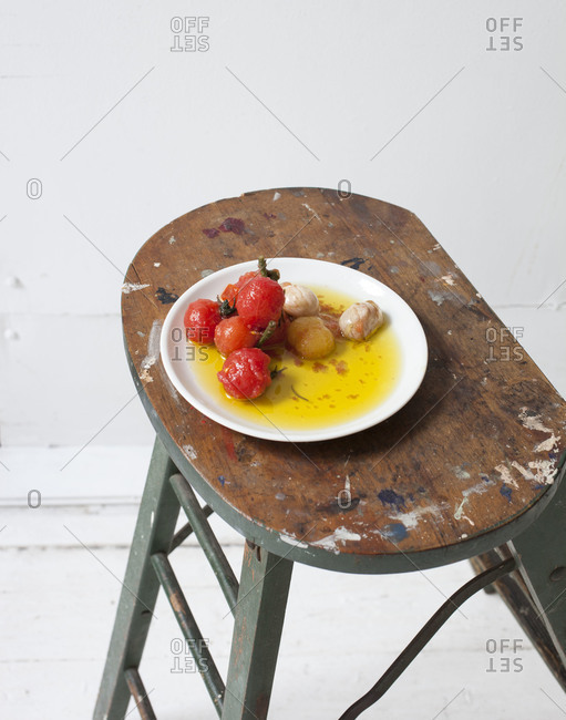 Tomato pickles with garlic served on a stool