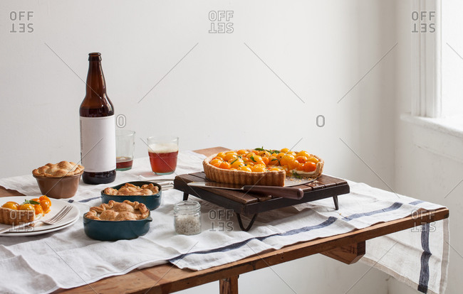 Tomato dishes served on a table with a bottle of beer