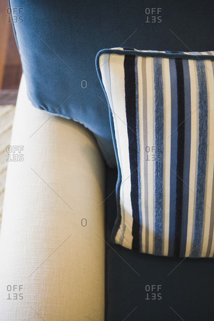 Detail blue and white striped throw pillow on armchair