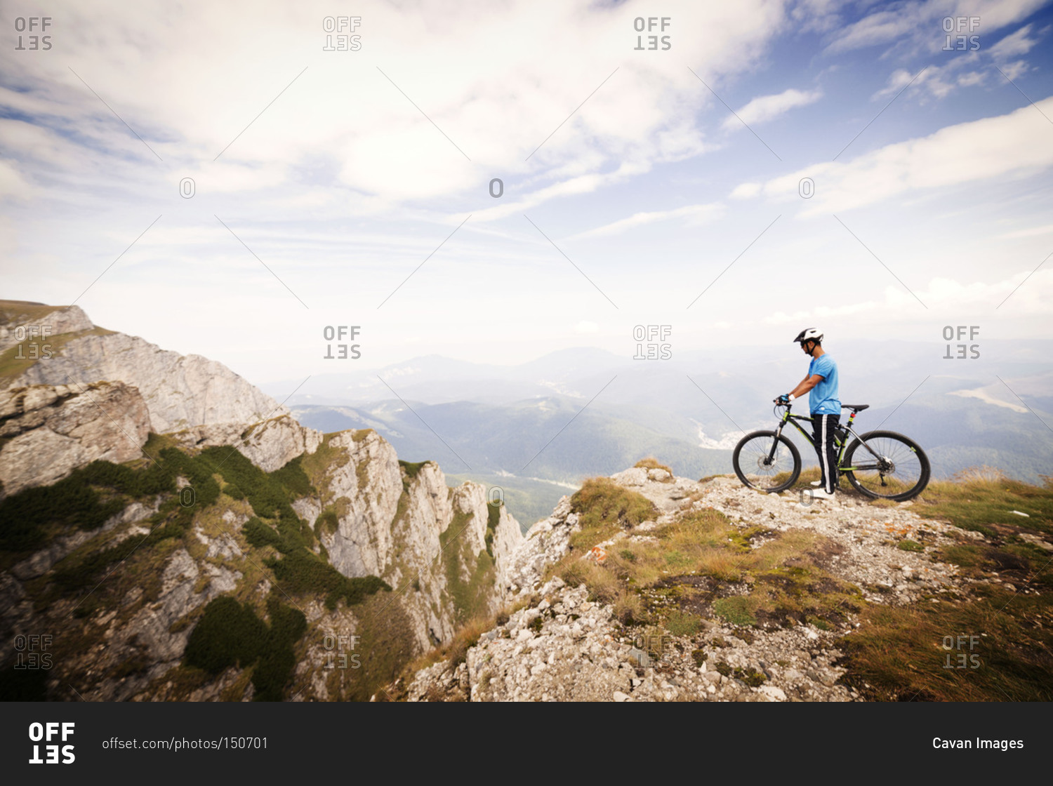 Bicyclist on mountain at scenic overlook, Carpathian Mountains
