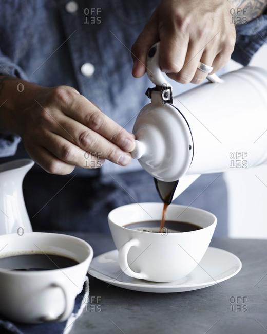 Man Pouring Coffee Into Cup From Metal Pot Stock Photo Man Pouring Coffee Into Cup From Metal Pot Stock Photo