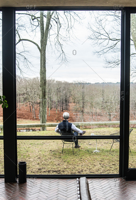 New Canaan, Connecticut - May 10, 2000: Man sitting outside the Glass House in New Canaan, Connecticut