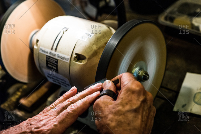 Craftsman polishing a piece of leather
