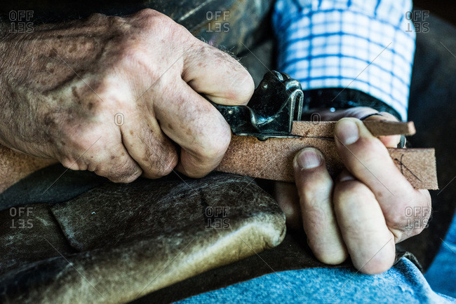 Craftsman cutting a piece of leather