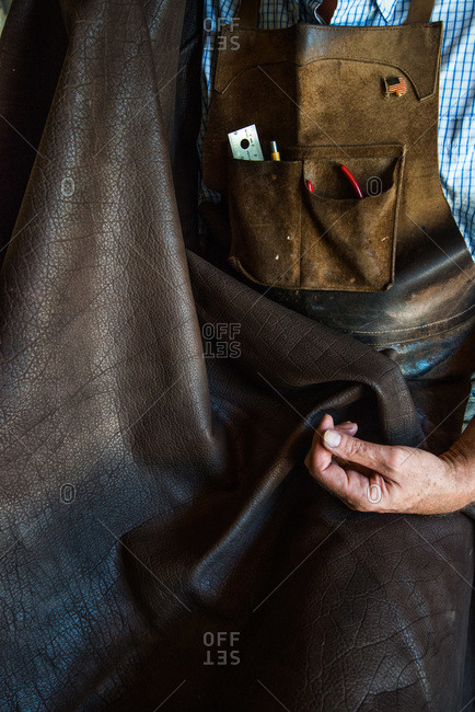 Artisan holding a piece of leather