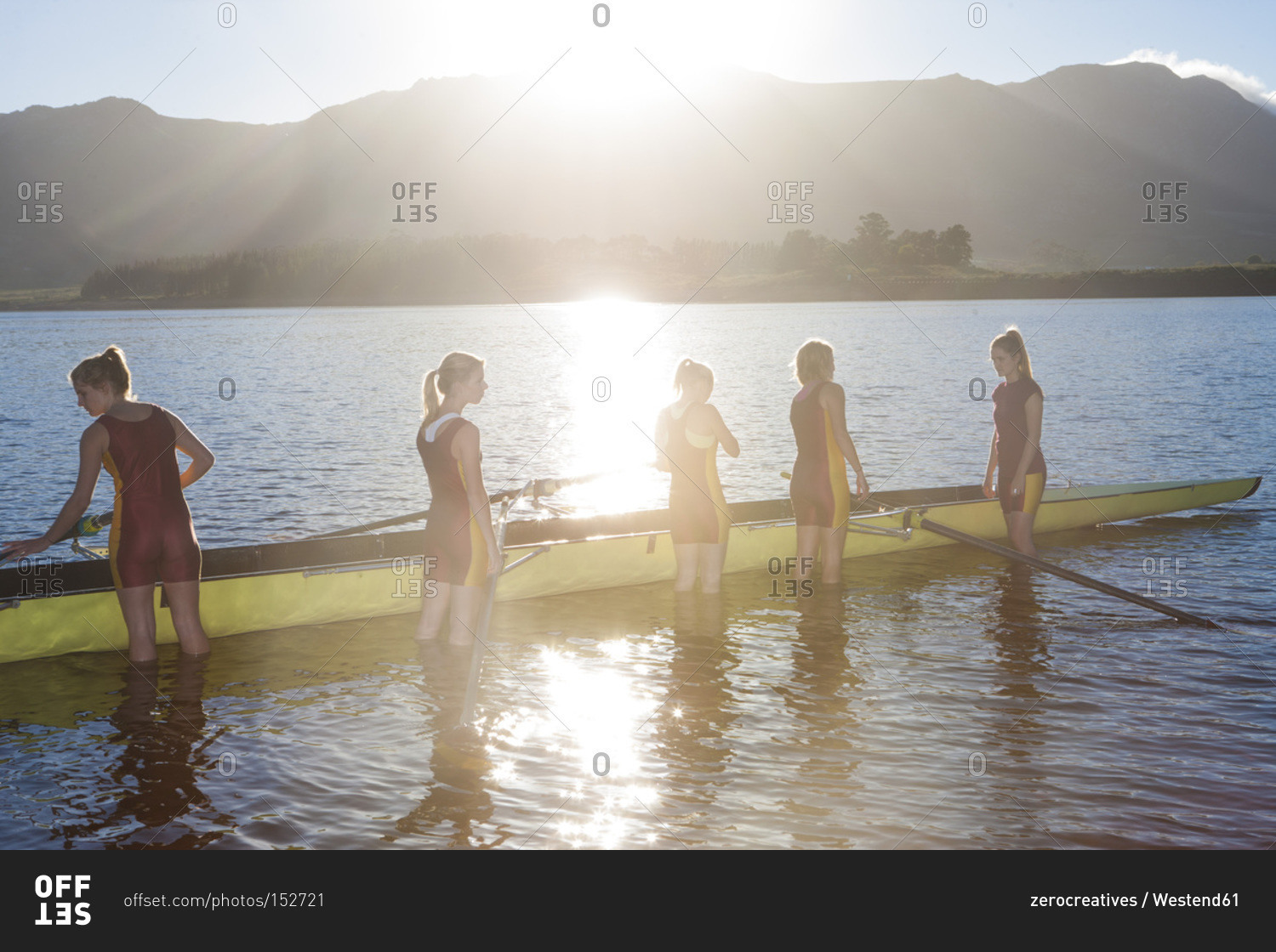 Five female rowers in water