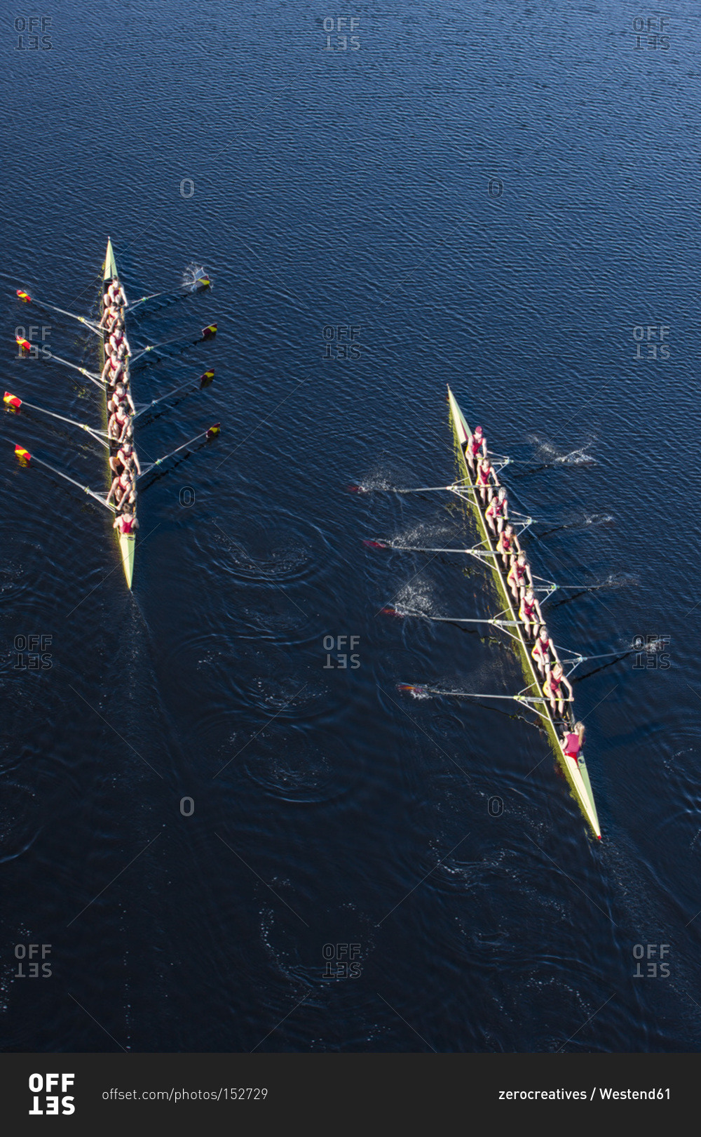 Overhead view of two rowing eights in water