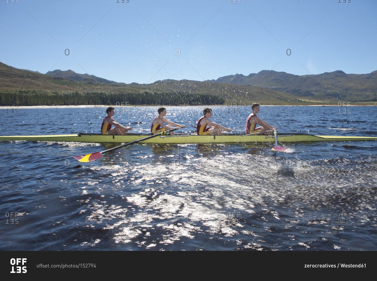 Profile of a coxless four rowing boat in water