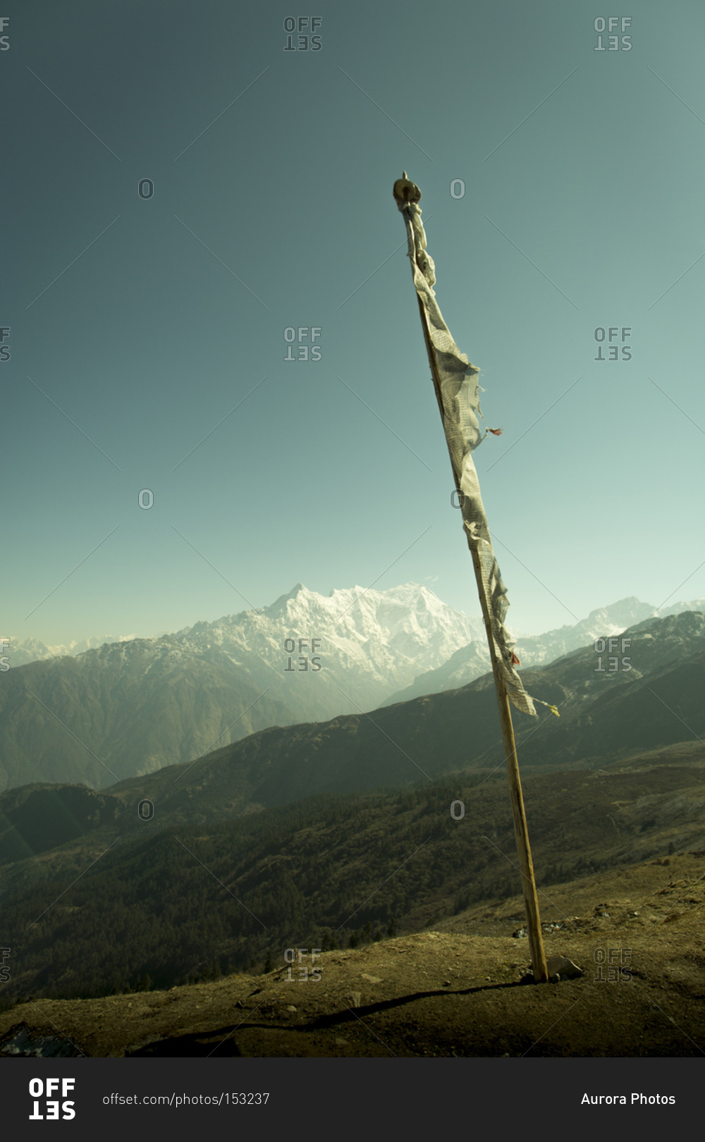 A prayer flag overlooks the Langtang Region of Nepal's Himalayan Mountain Range