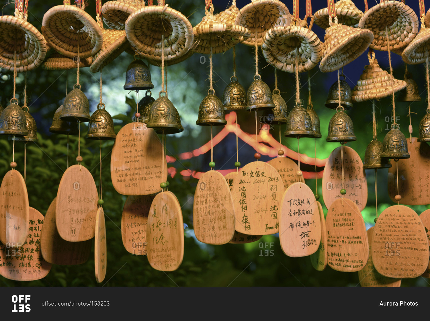 Lucky charms in form of small bells, wicker hats and wooden plates with Chinese hand writing at Shenyuan in Shaoxing