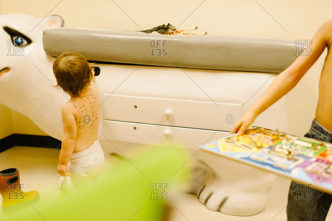 Two children in a pediatric exam room