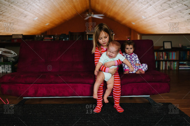 Children in a loft with crying baby