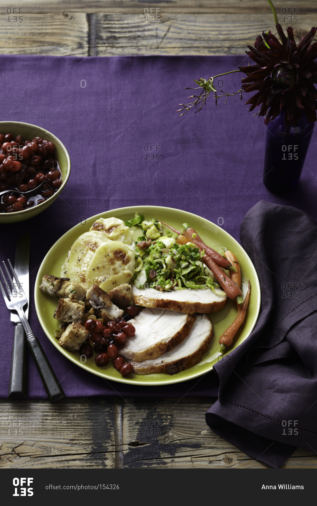 Sliced turkey served with Thanksgiving sides