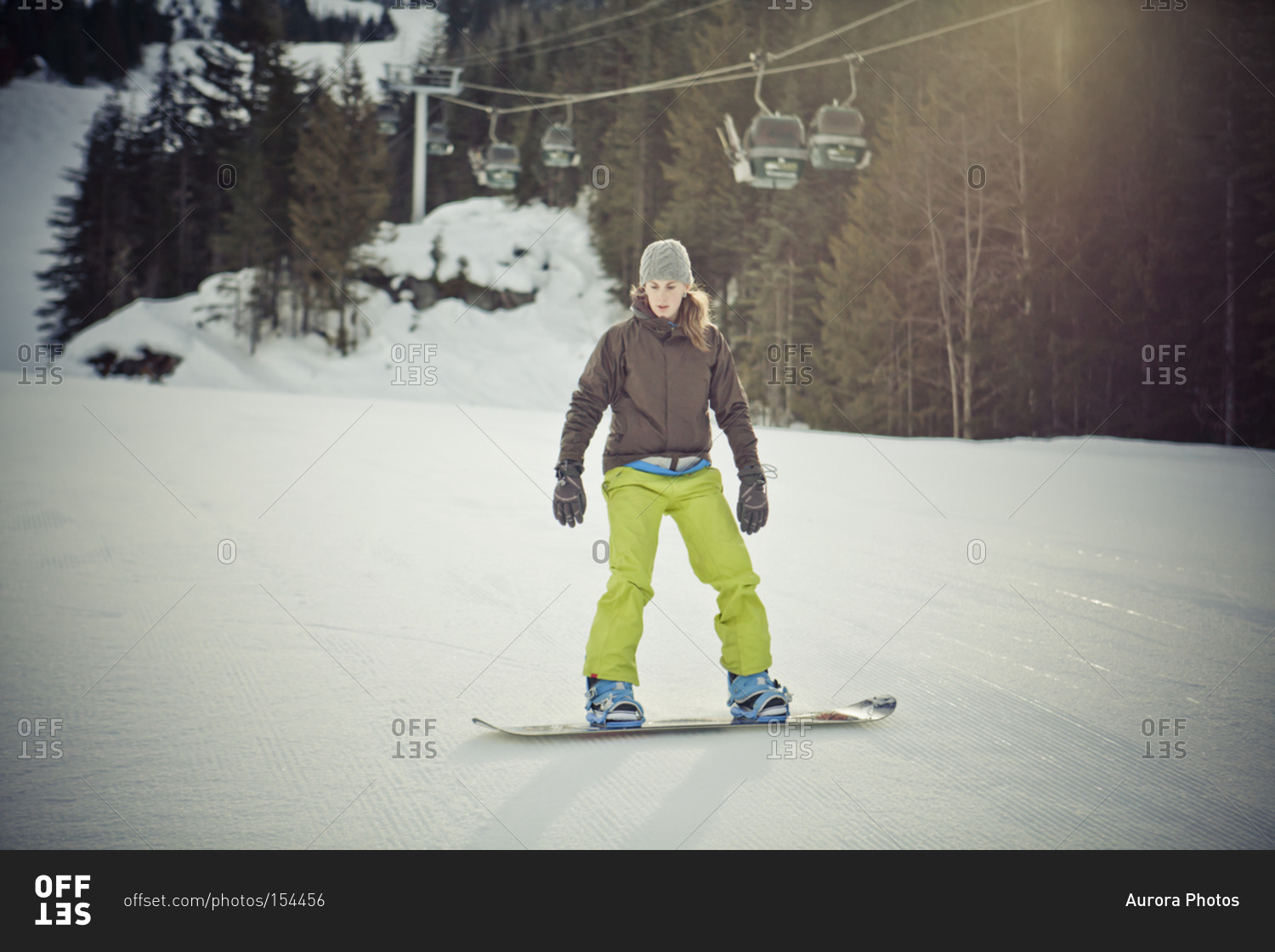 A young woman snowboarding on Whistler Mountain