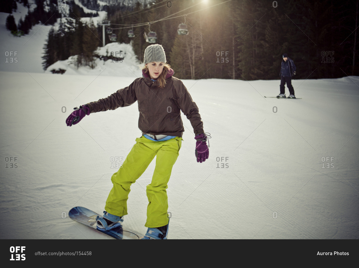A young woman snowboarding on Whistler Mountain