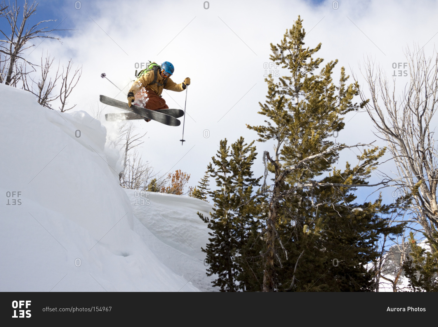A male backcountry skier catches air off a cornice in the Beehive Basin near Big Sky, Montana