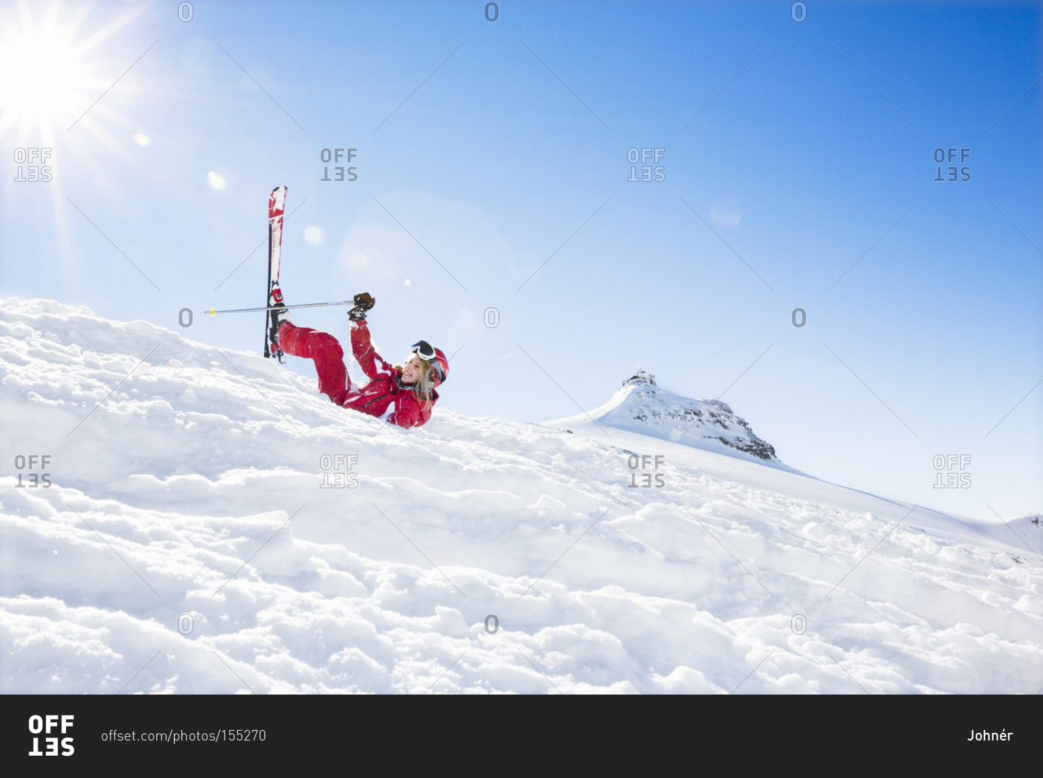 Woman falling while skiing
