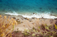 Narrow shoreline with seaweed from above