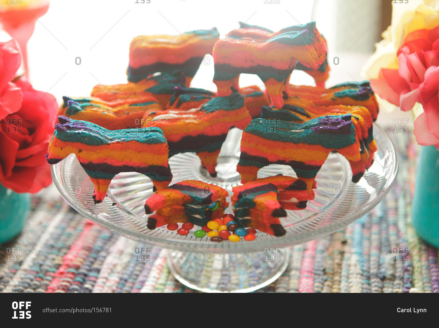 Horse-shaped rainbow cookies on a cake stand