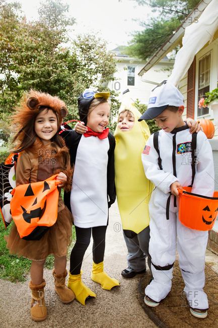 Kids posing for picture in Halloween costumes