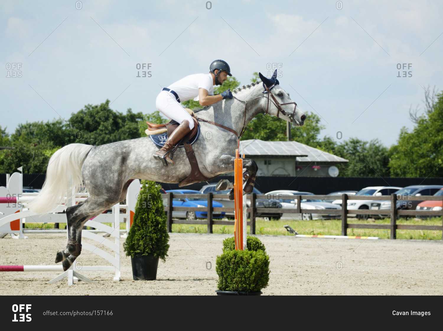 Man on horse jumping during competition