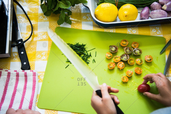 Person slicing tomatoes on a cutting board