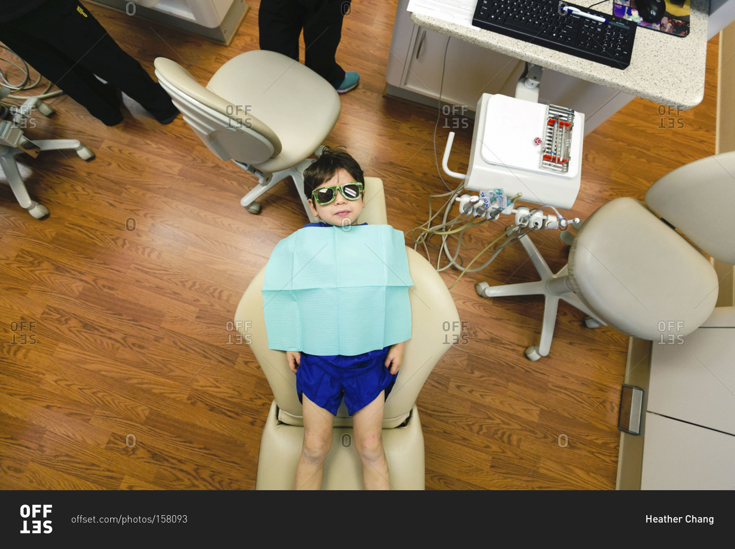 Overhead of boy in dentist's chair with bib