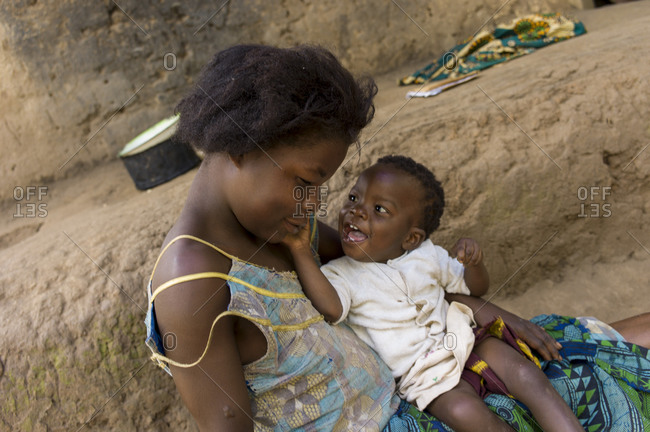 Ndallam Village, Malawi - April 30, 2013: Lekeleni Harrison cuddles her daughter Abigirl (1 year 4 months) who is unable to walk and is being checked for polio