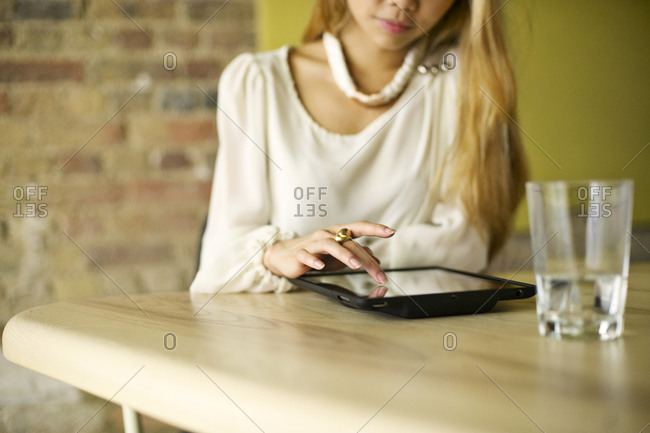 Woman touching the screen of a tablet computer