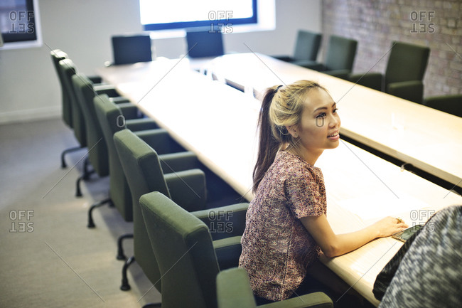 Woman sitting in conference room