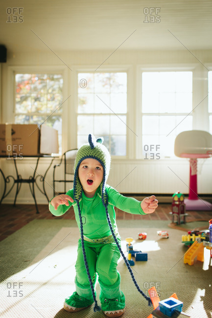 Boy imitating dinosaur in costume