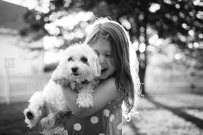 Portrait of a young girl holding a dog
