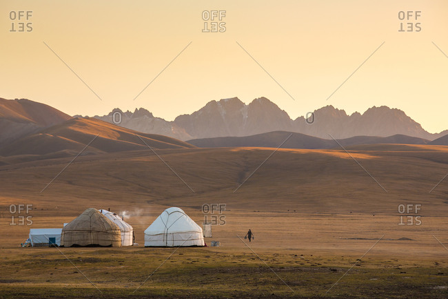 Woman Carrying Water to the Yurts in the Steppes of Central Asia