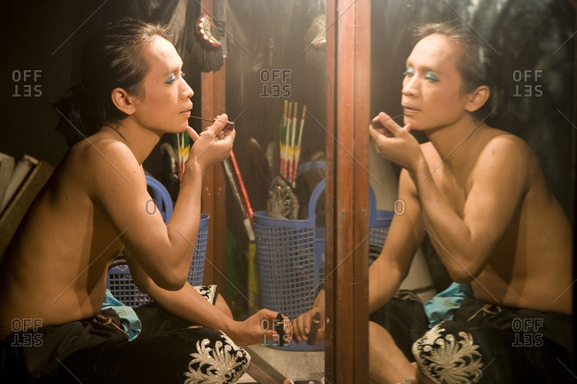 Yogyakarta, Java, Indonesia - September 22, 2007: Ramayana ballet dancer prepares makeup before a performance