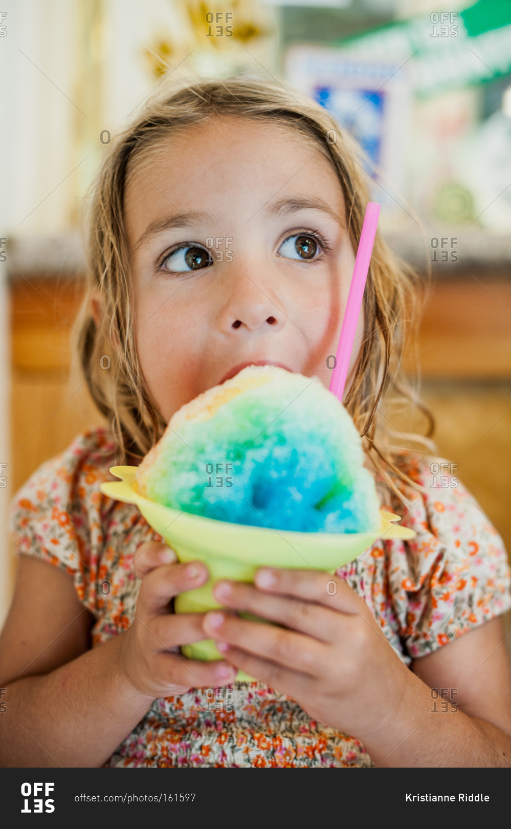 A girl eats a large italian ice stock photo - OFFSET