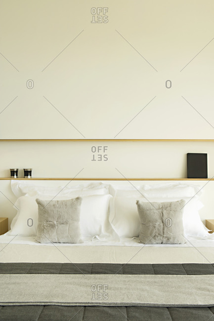 Fur throw pillows on a bed