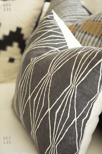 A throw pillow with a  geometric pattern