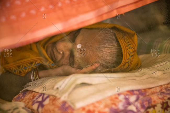 Varanasi, India - March 5, 2014: Widow sleeping in an ashram