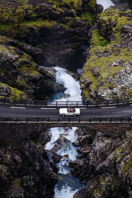 White sports car passing over a bridge at Trollstigen, Norway