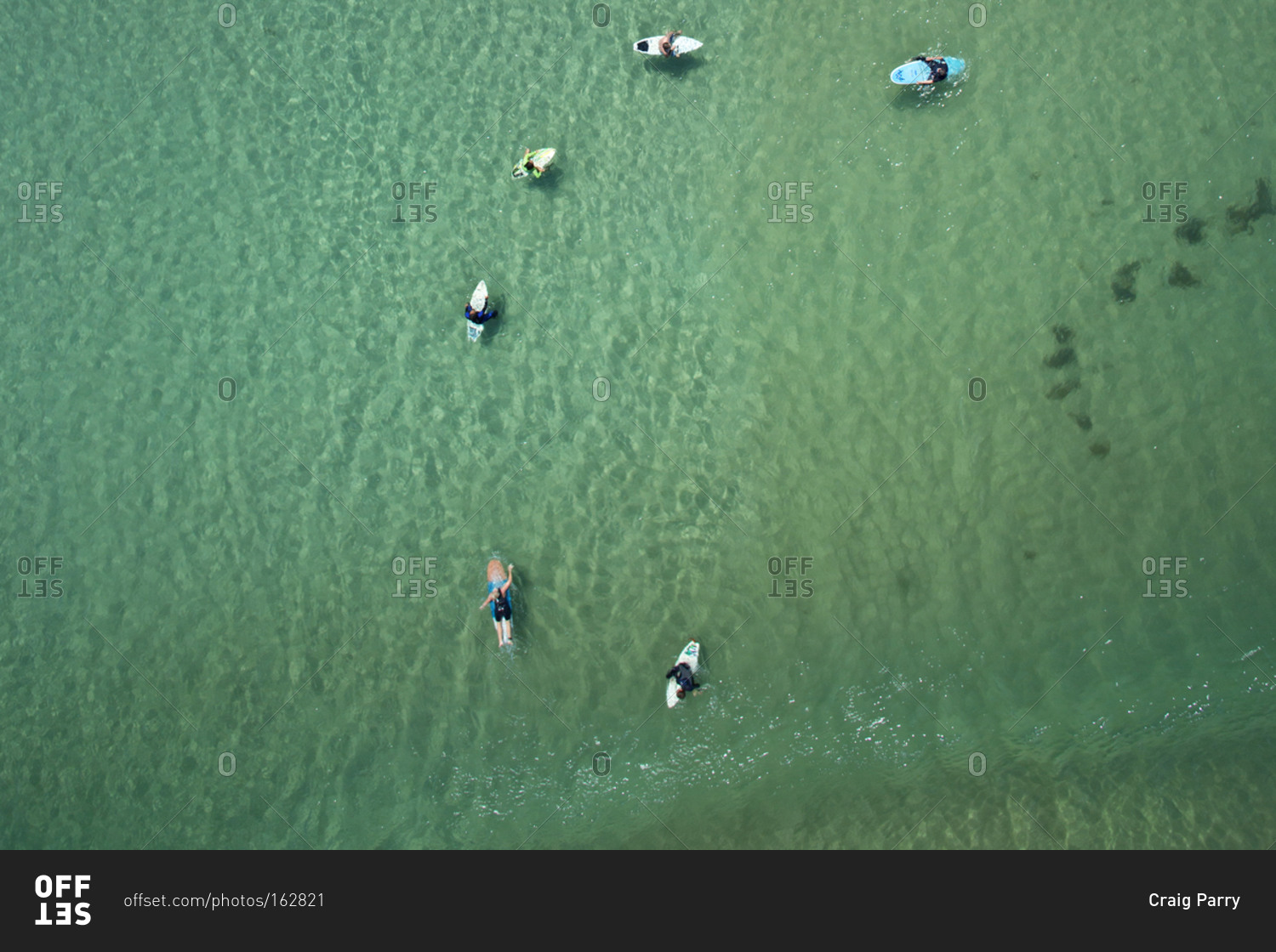 Aerial view of surfers in still water